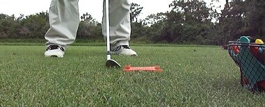 GTFlyr with Golf Ball and bucket filled with GTFlyrs GTFlyr with Golf Ball